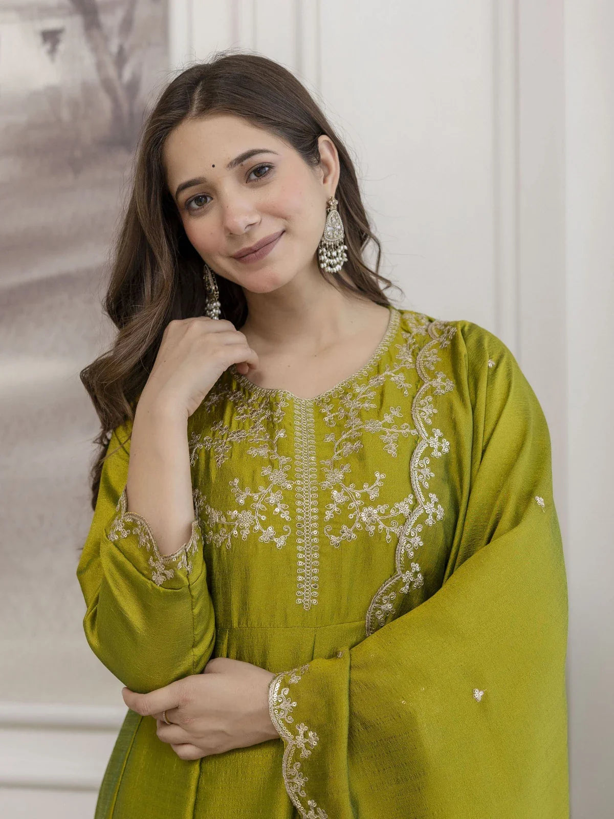 Tarani green silk dress close-up showing embroidered neckline and sleeves