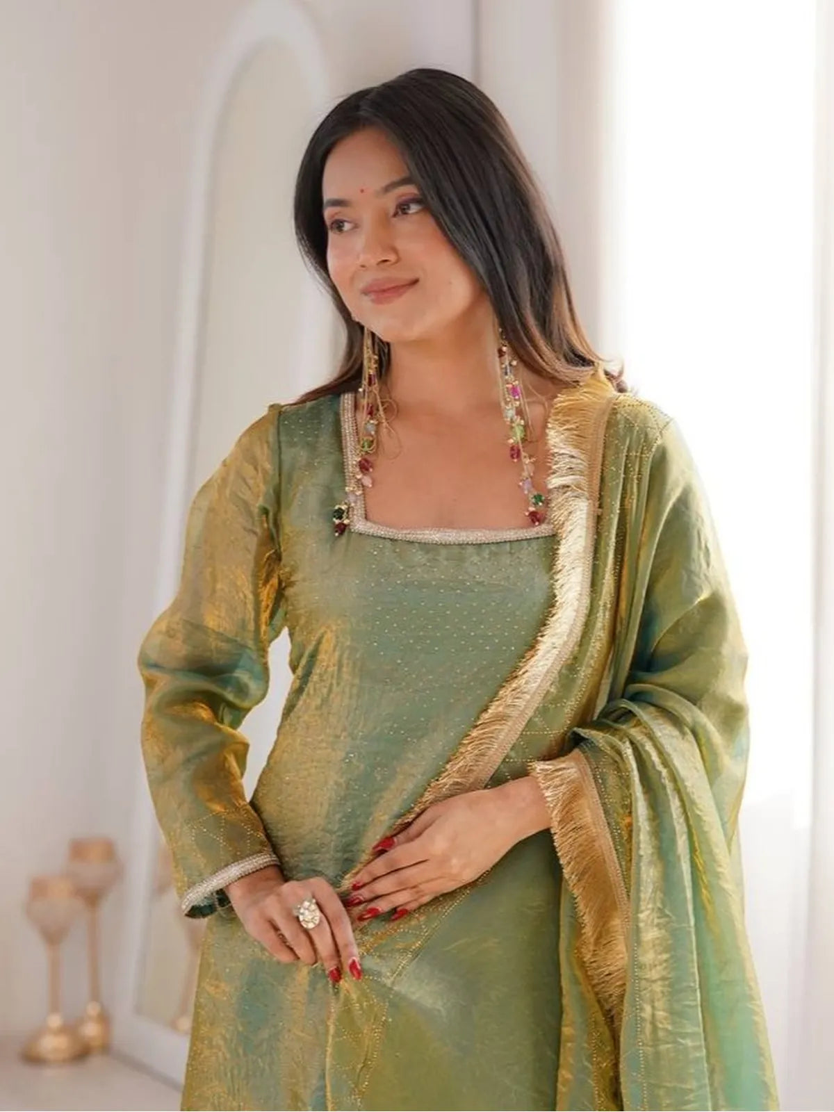 Tarani green silk dress close-up showing neckline and lace details