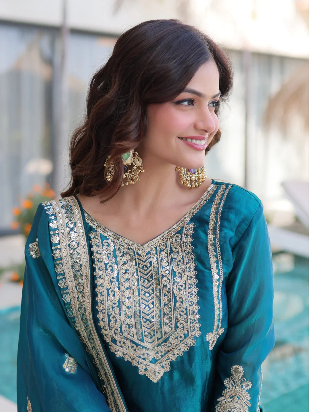 Tarani designer green silk dress with close-up on neckline and sleeve embroidery