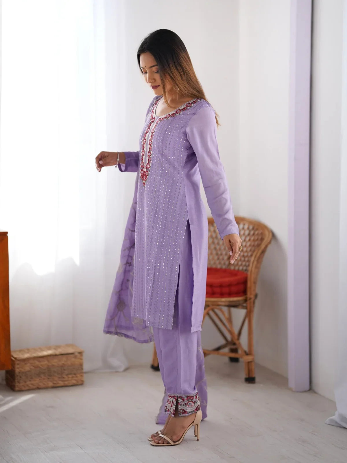 Tarani side pose of embroidered lavender chinon silk partywear kurti with sequin highlights