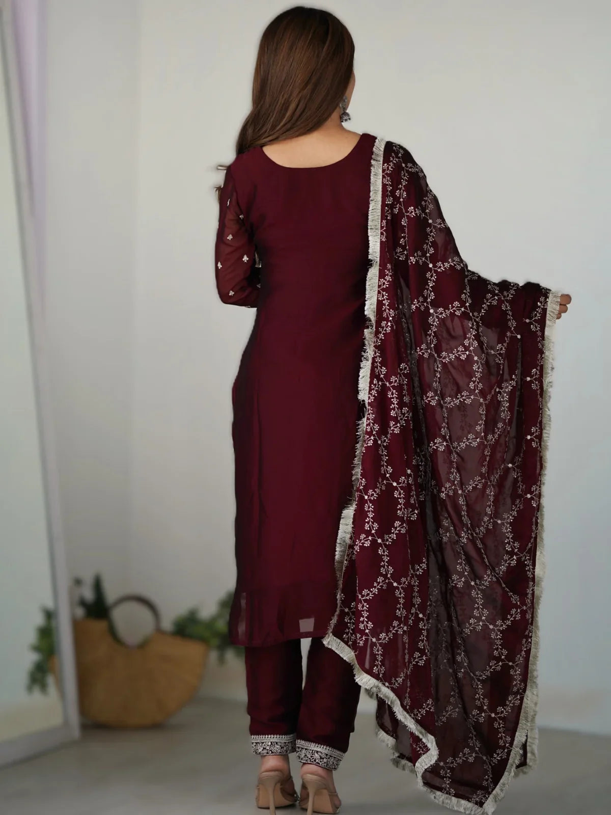Tarani back view of maroon embroidered silk dress with elegant dupatta drape