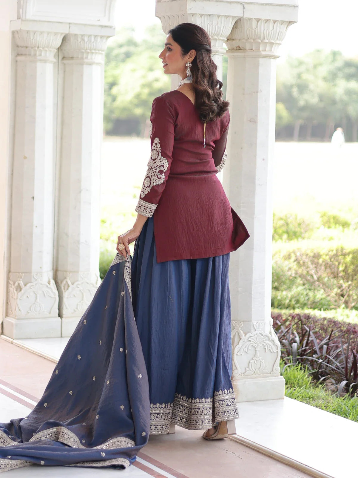 Tarani back view of maroon silk embroidered dress with long sleeves and flared sharara