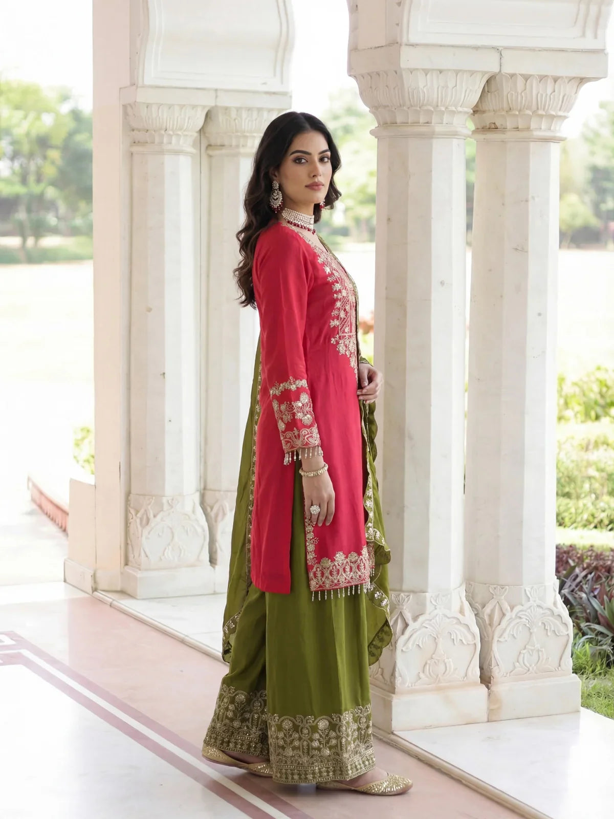 Tarani side view of pink kurti with green embroidered palazzo and statement jewellery
