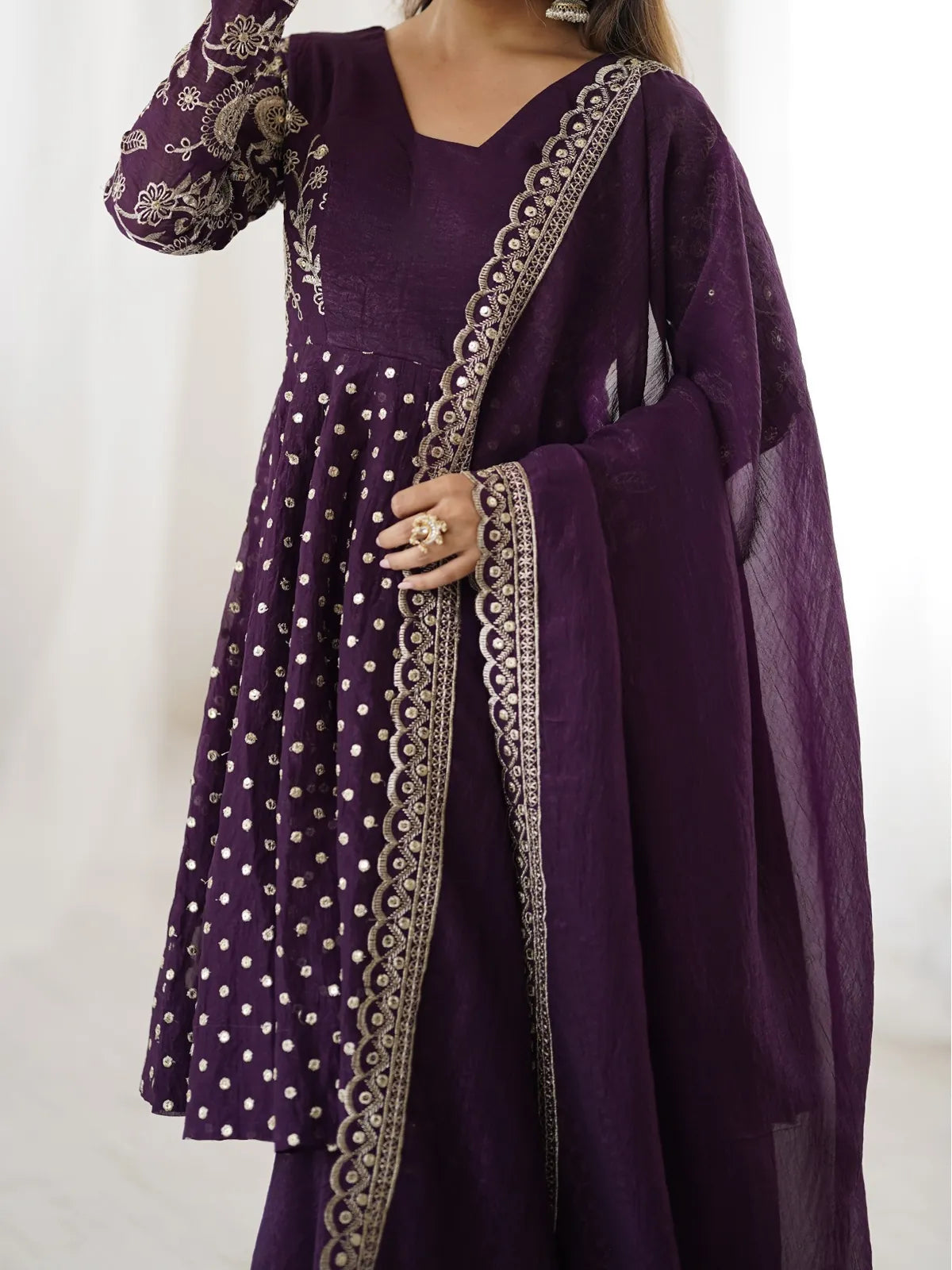 Tarani purple silk dress closeup showcasing golden sequence embroidery work