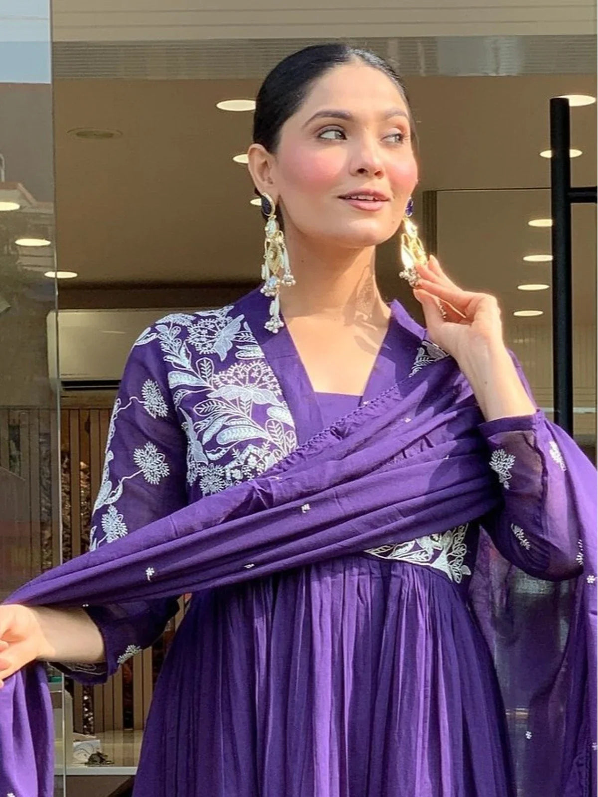 Tarani upper body close view of purple silk dress with elegant neckline and embroidery