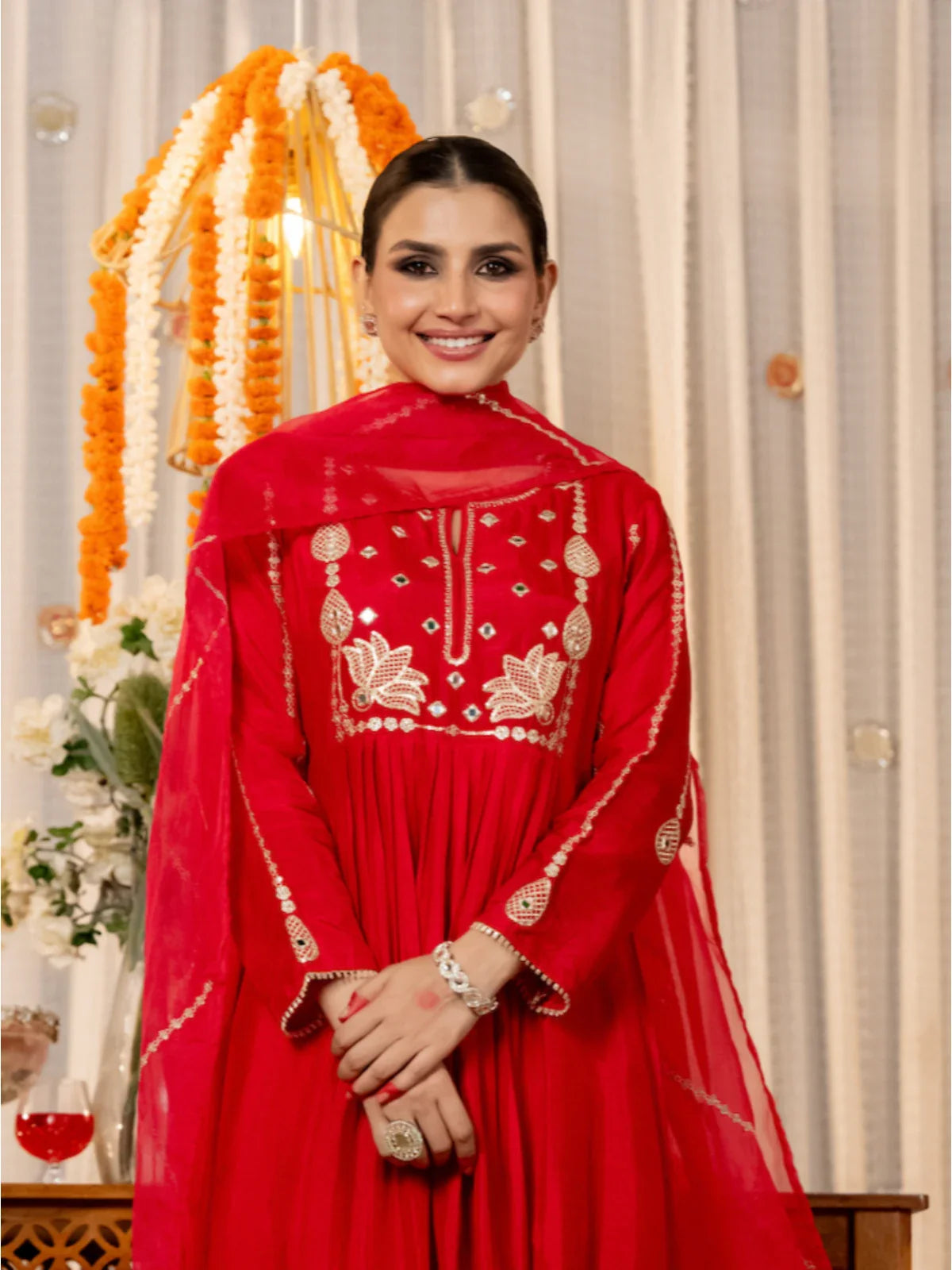 Tarani red silk dress close-up showing detailed neckline embroidery and festive styling