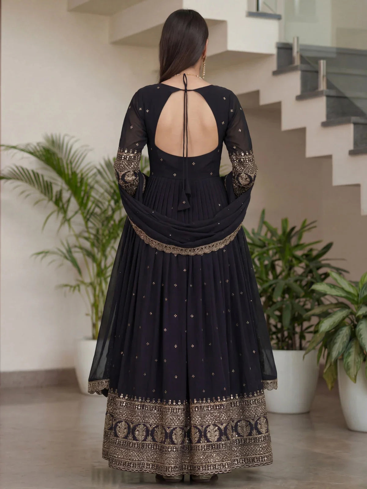 Tarani black silk gown back design with tie-neck and full flair view