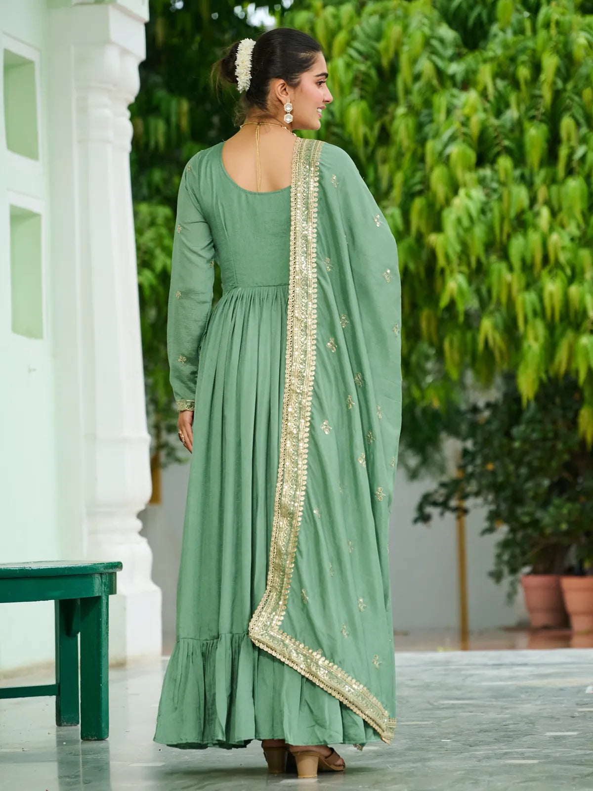 Back side of Tarani green gown showing full back design and dupatta fall