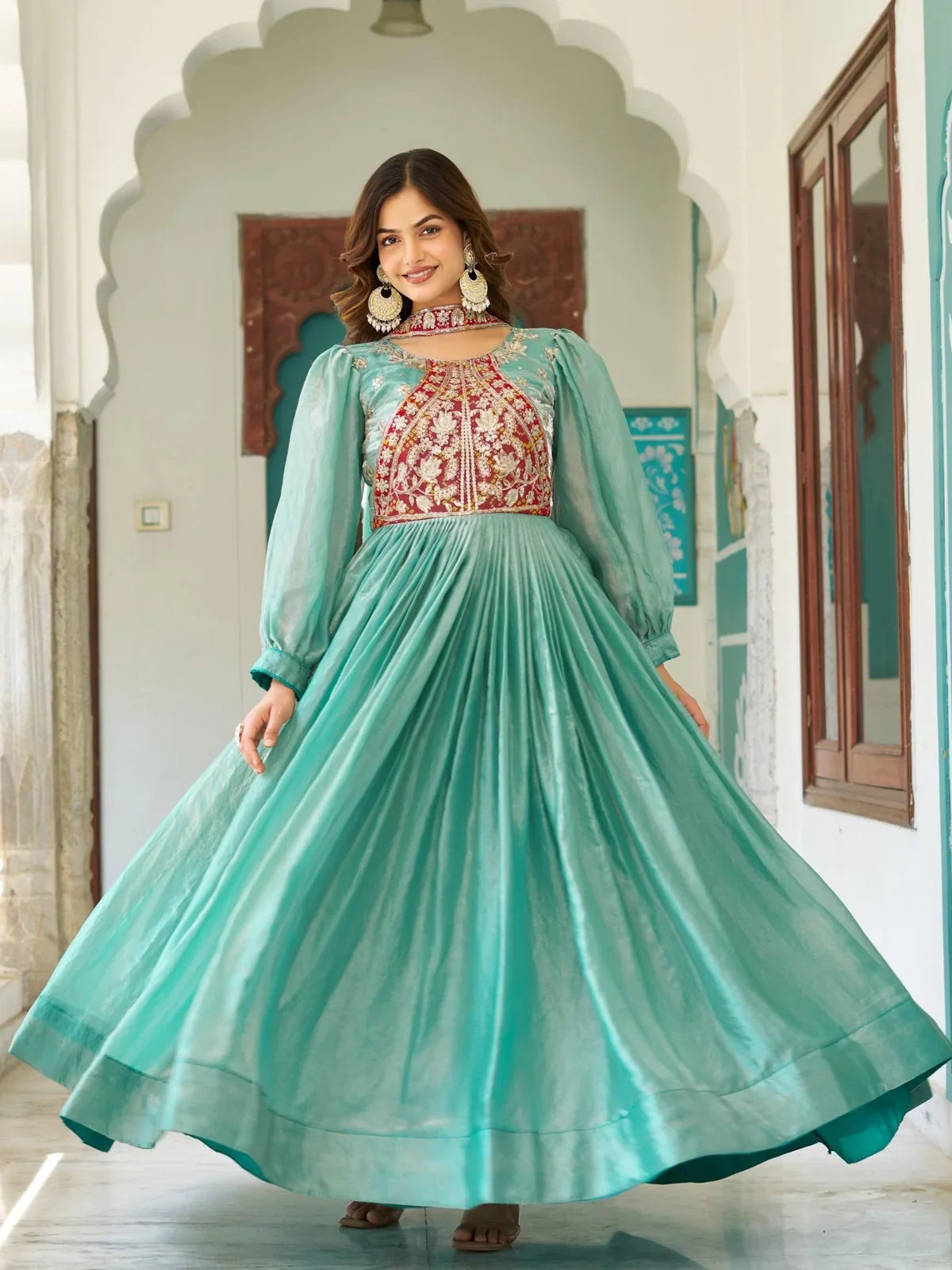 Tarani designer gown in sea green silk, front view highlighting flare and festive detailing for celebrations