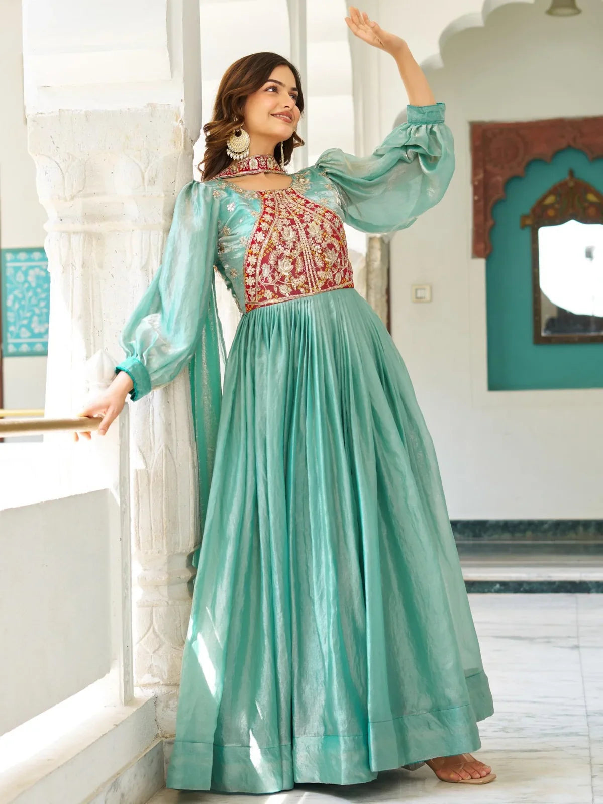 Tarani green silk gown with full view showcasing its elegant flow and embroidered neckline for weddings