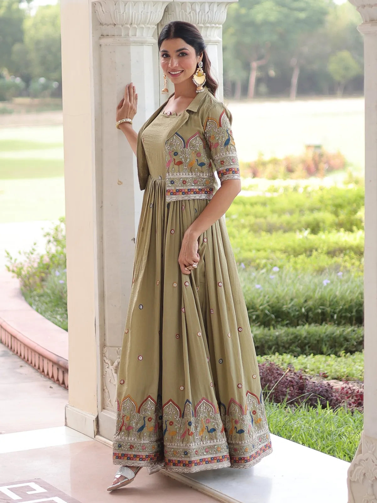 Tarani festive green silk gown side profile with intricate embroidery and flared silhouette