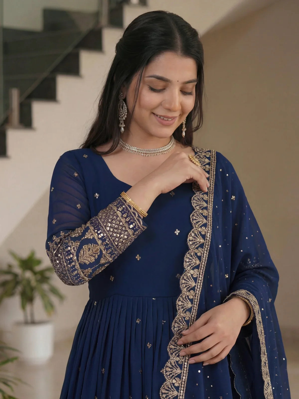 Tarani navy blue silk gown close-up showing neckline and embroidered sleeves