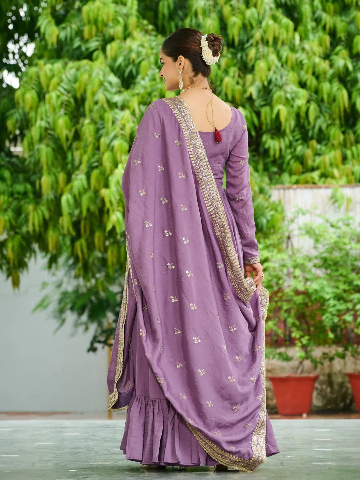 Tarani back view of purple embroidered gown with dupatta and gajra hair styling