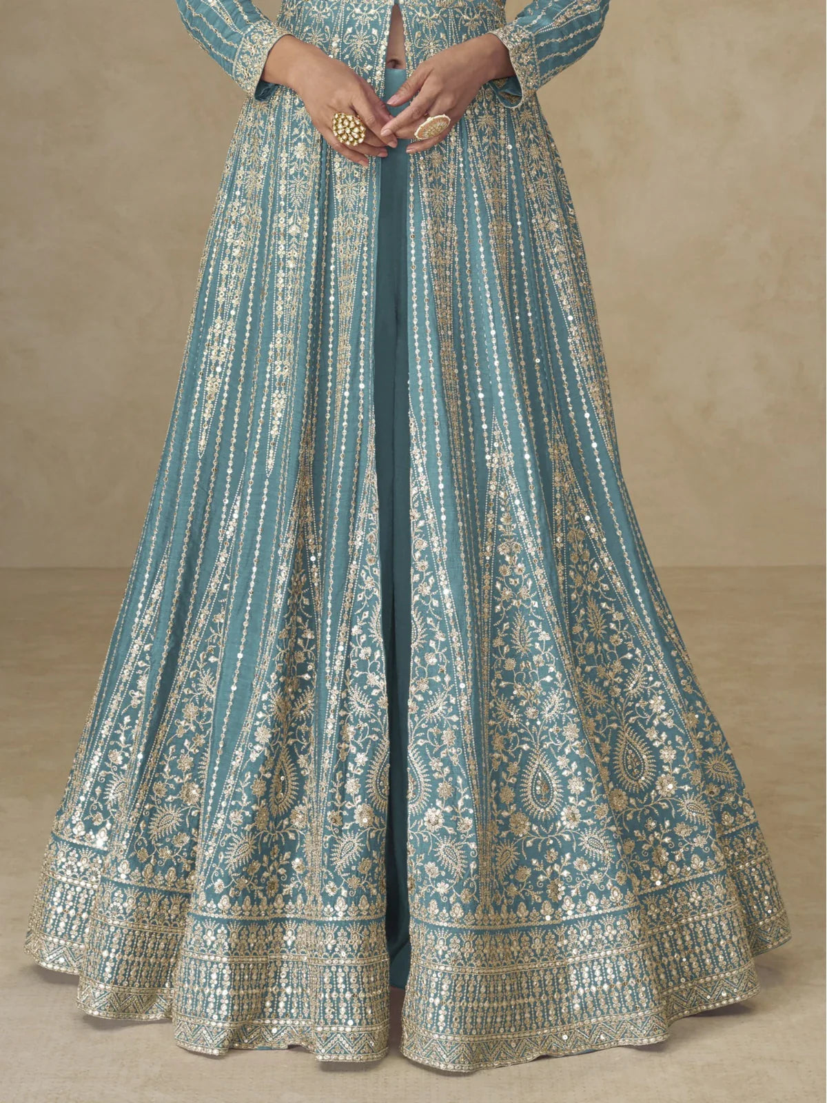 Tarani teal silk gown hemline close-up highlighting zari embroidery patterns