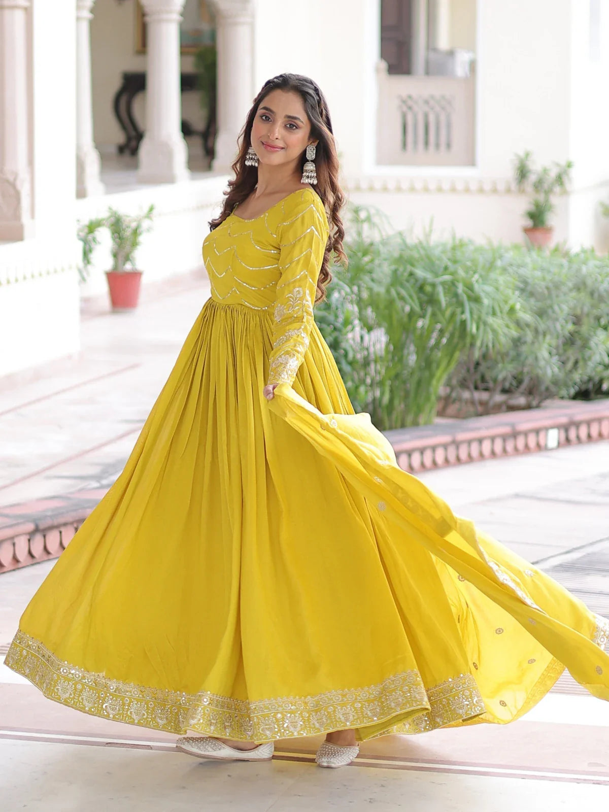 Tarani yellow silk gown with twirling flare captured from front angle – festive gown