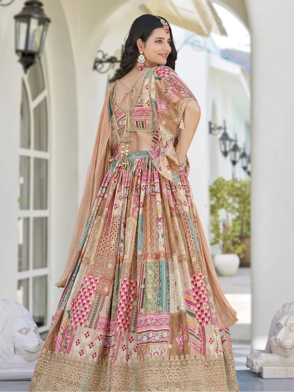 Back design of Tarani premium beige lehenga with embroidery and tie-up blouse pattern