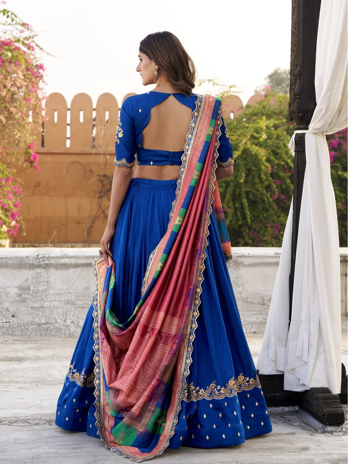 Tarani blue lehenga back view with blouse back design and elegant dupatta drape