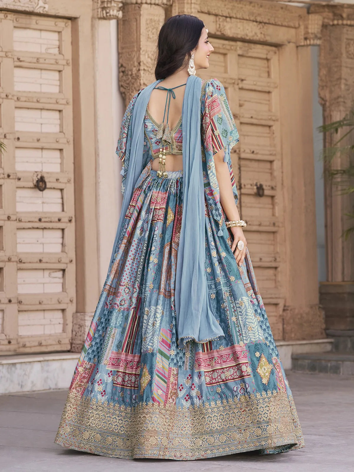 Tarani designer blue silk lehenga back view with tassel tie-up blouse and chiffon dupatta with lace