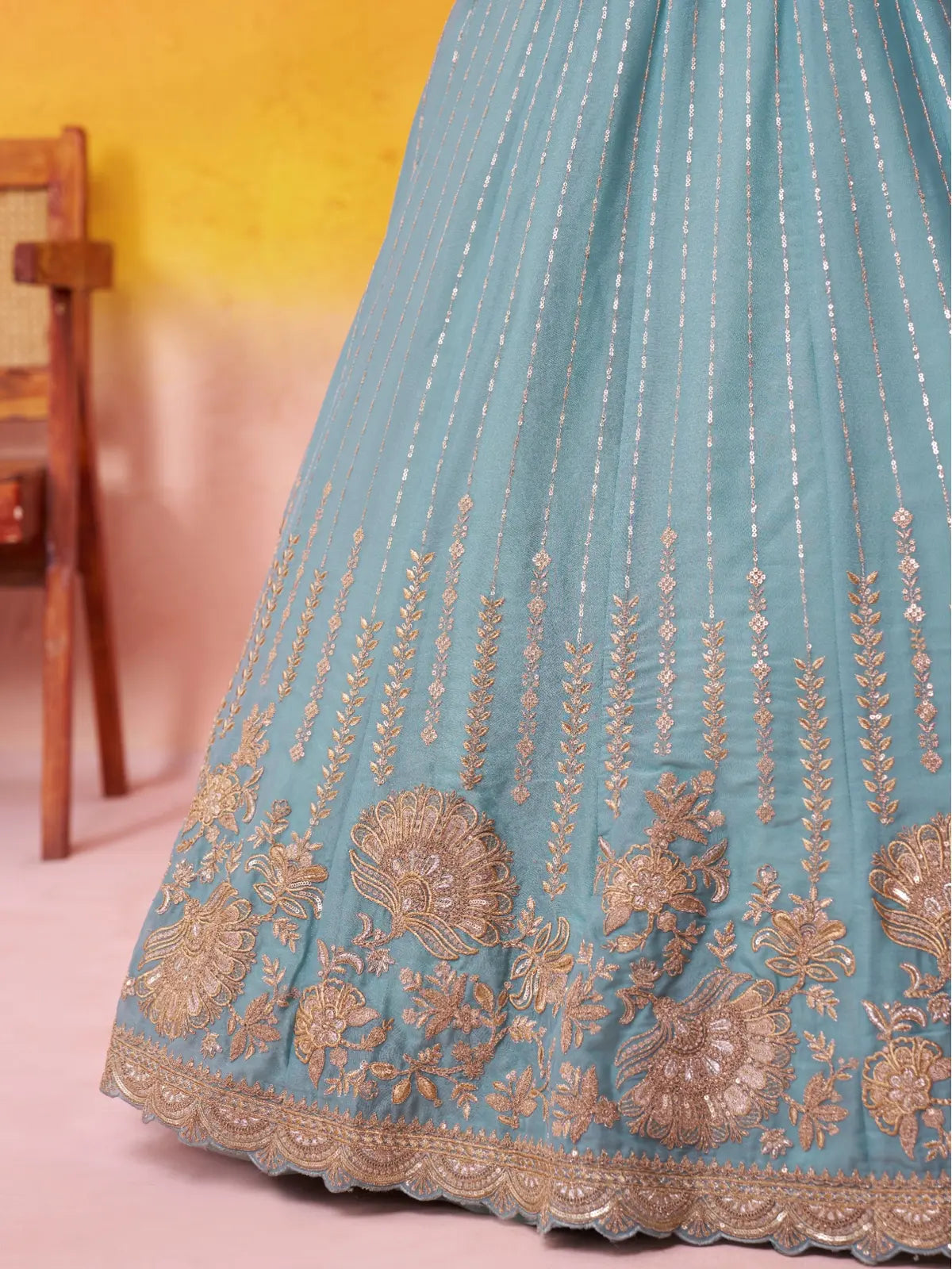 Tarani detailed closeup of lehenga border with golden floral coding and threadwork embroidery
