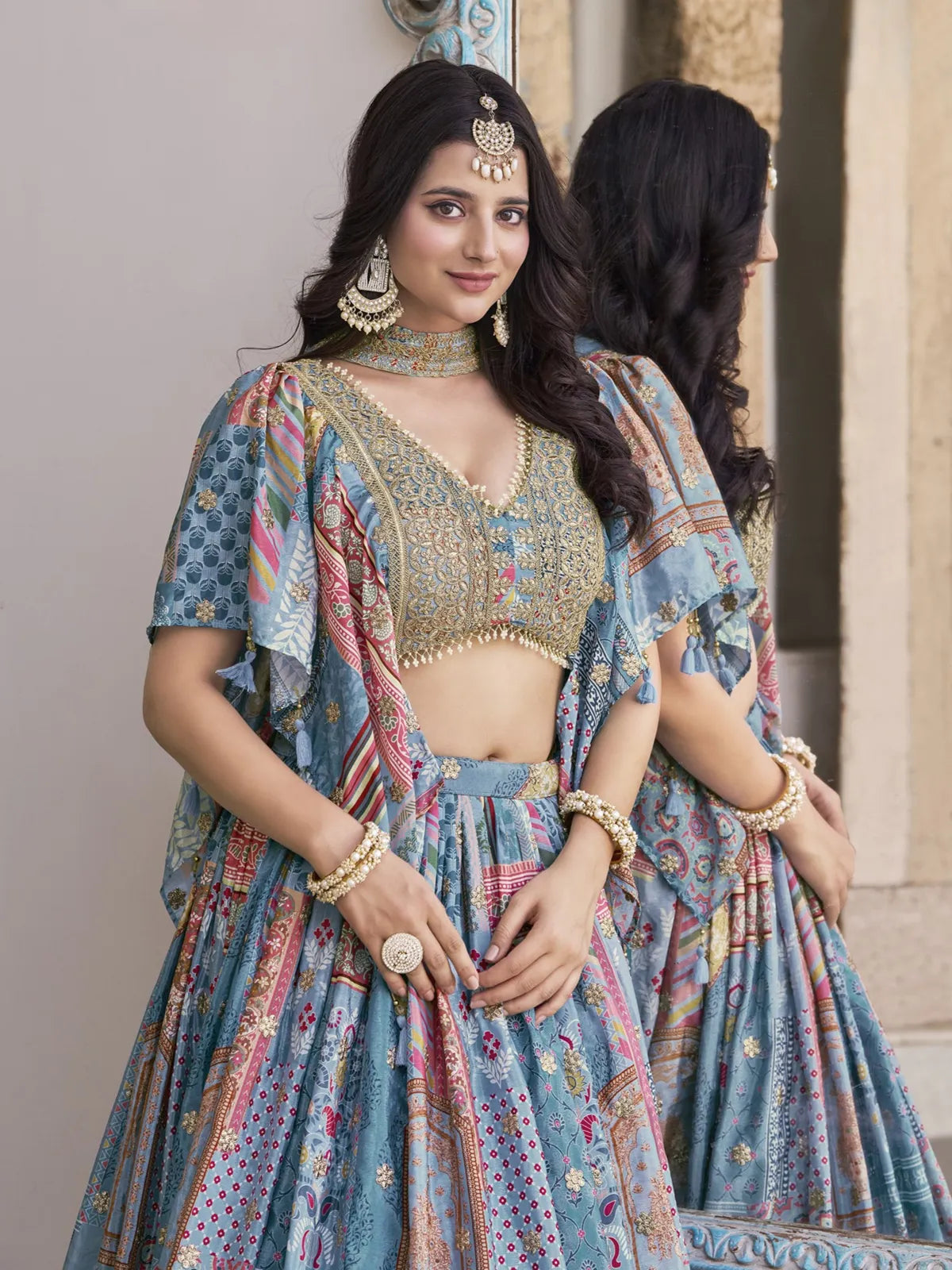 Tarani blue silk lehenga with embroidered blouse close-up, elegant zari neckline and festive jewellery