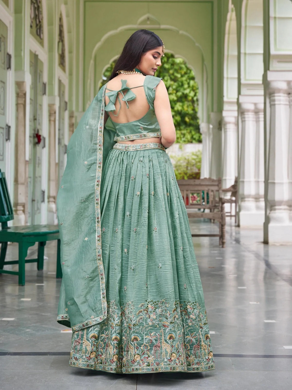 Tarani green lehenga back view showing blouse tie-up and embroidered flare design for festive wear
