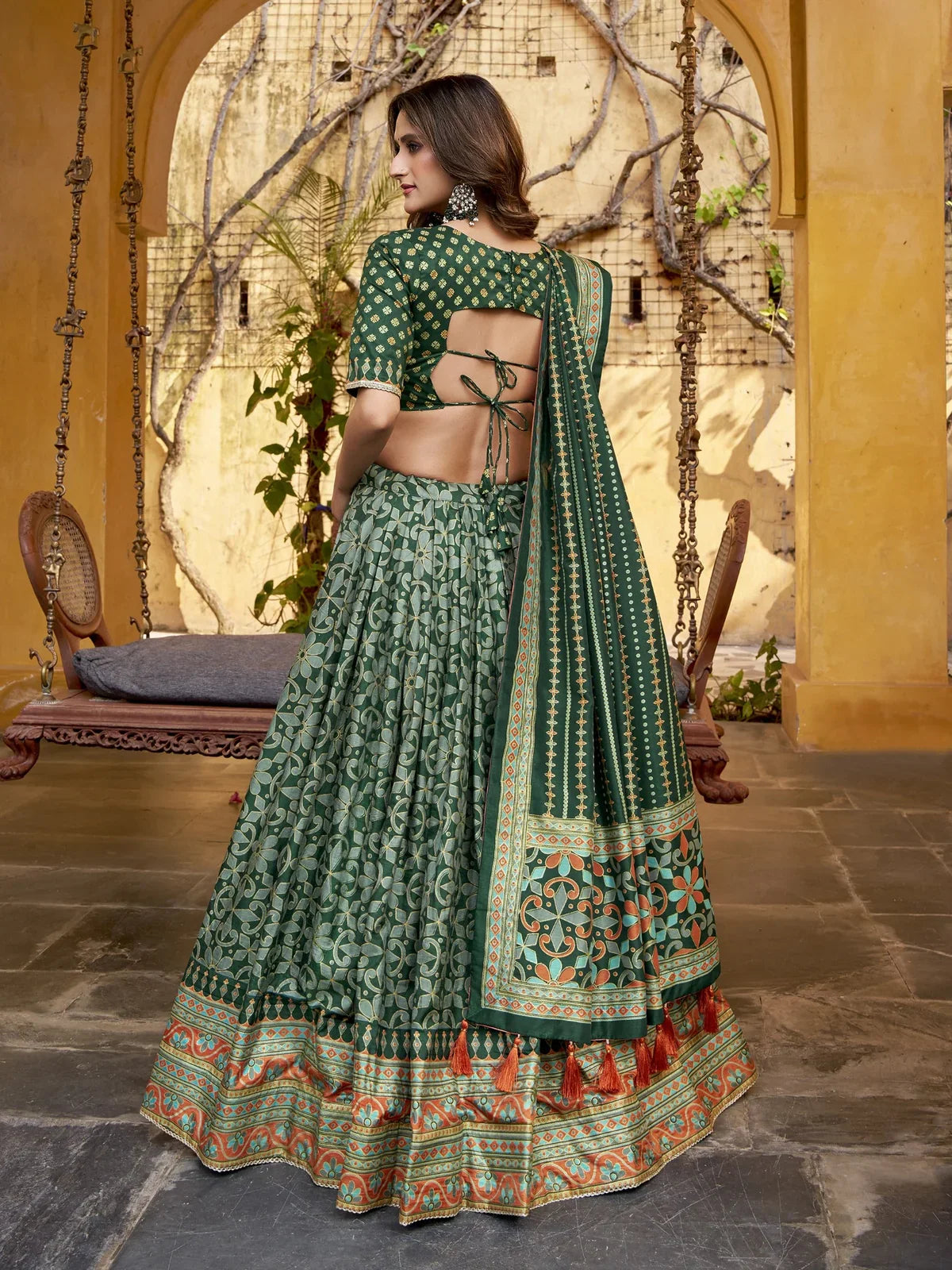 Tarani green silk lehenga back view showing elegant tie-back blouse and rich traditional dupatta design