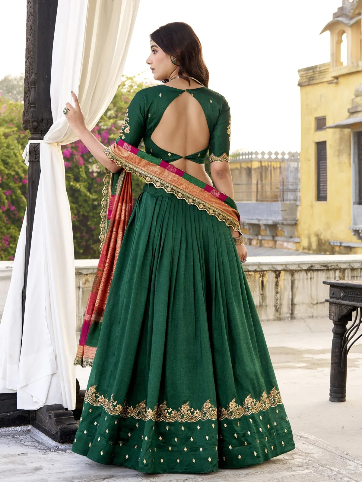 Tarani green lehenga back view showing stylish blouse design and dupatta drape for cultural wear