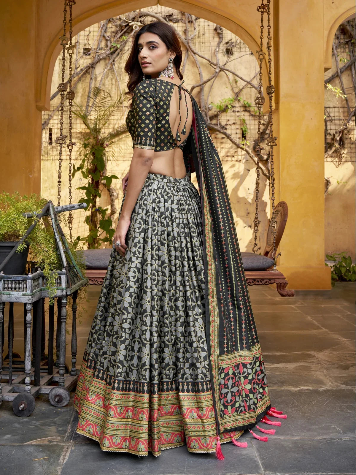 Tarani lehenga back design with deep cut blouse and tied string pattern in rear view