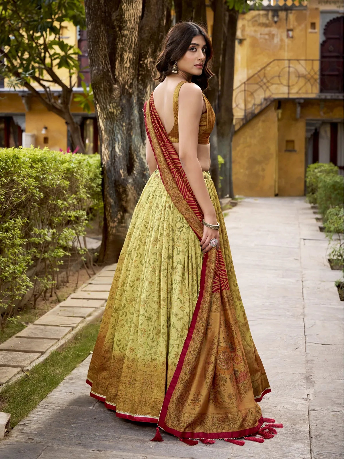 Tarani lehenga back view with green printed skirt and rich red border dupatta