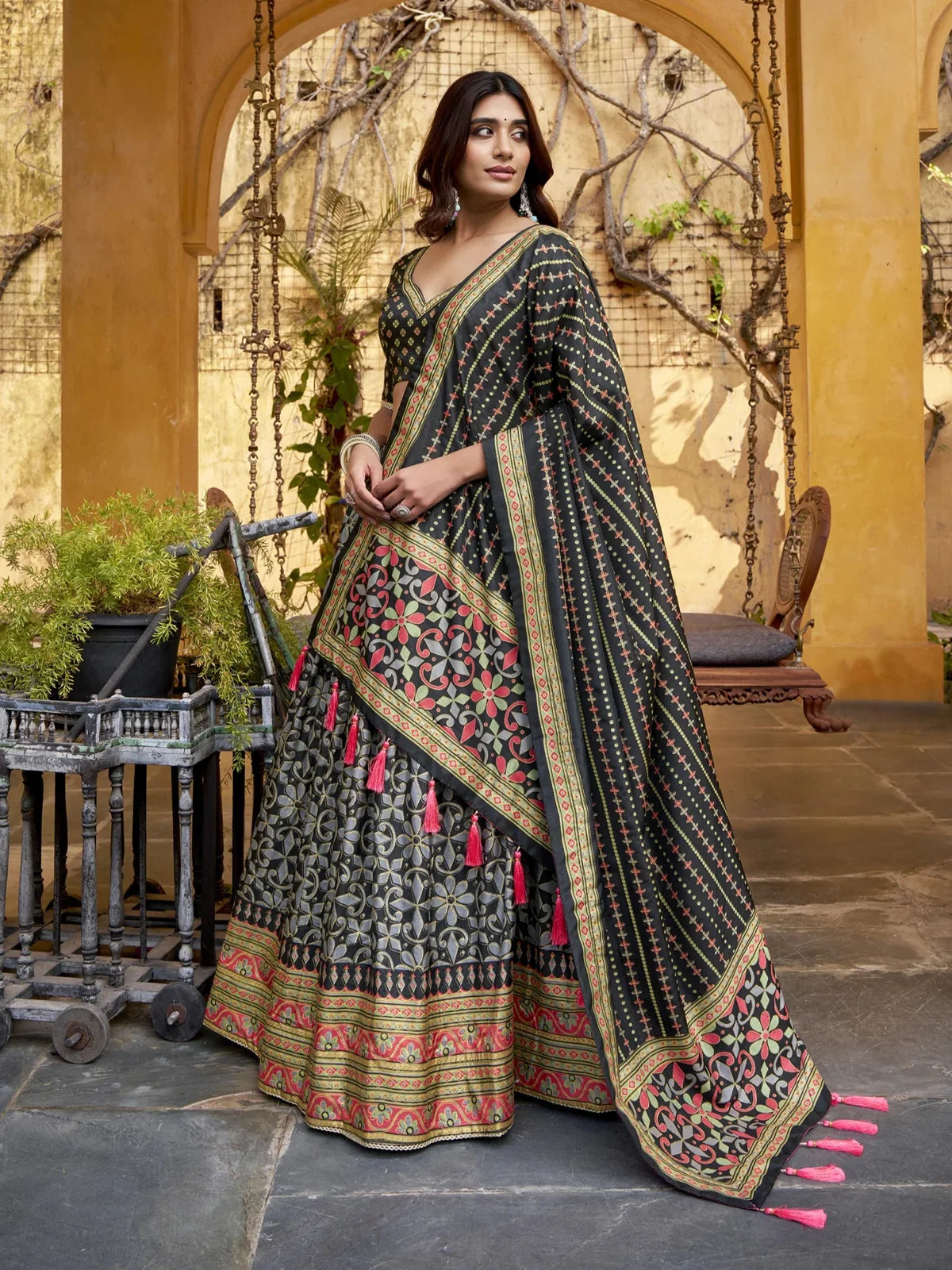 Tarani lehenga showing detailed side pose with traditional tassels and dupatta border