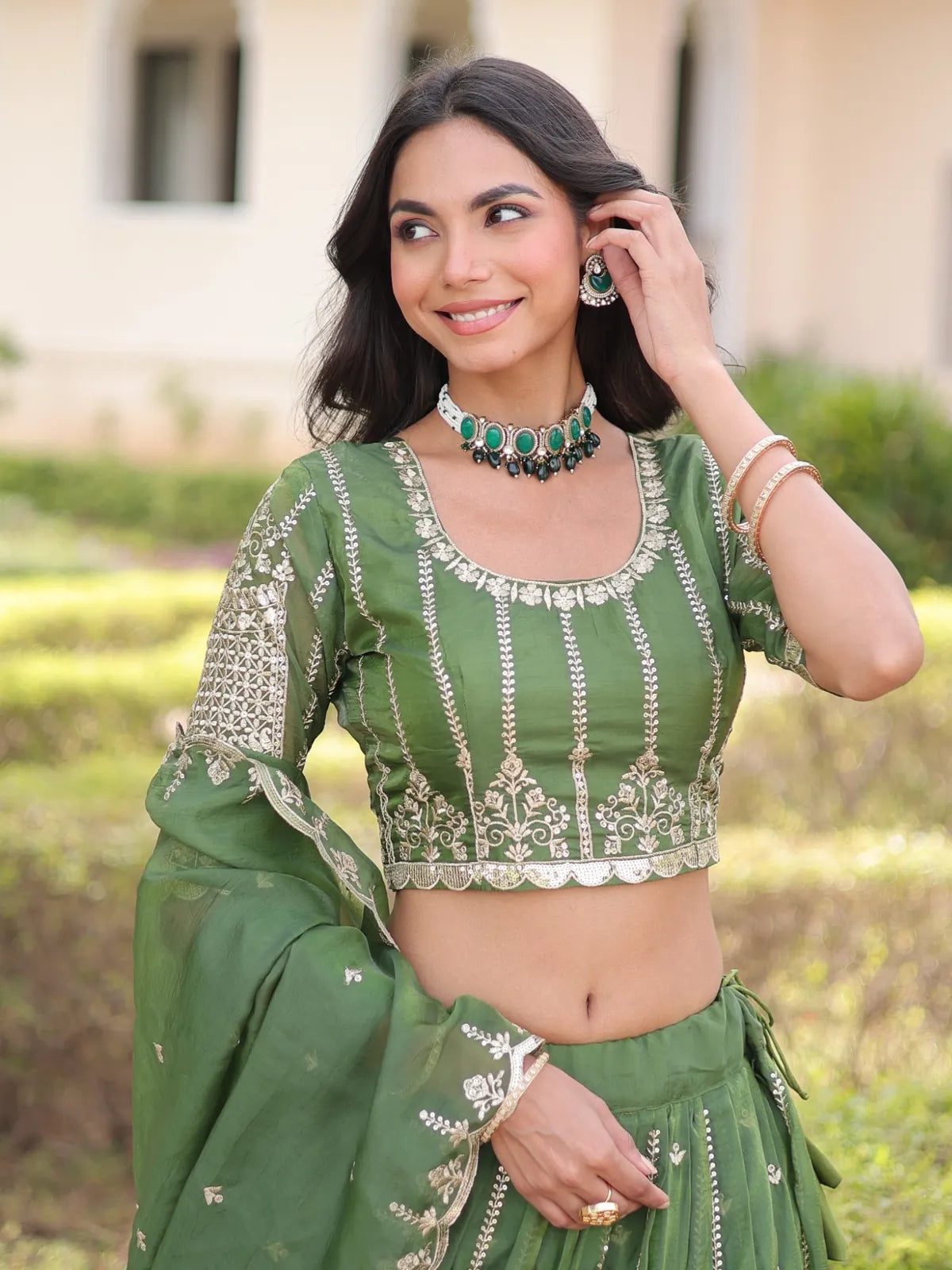 Tarani silk lehenga closeup showing intricate green blouse embroidery with zari work