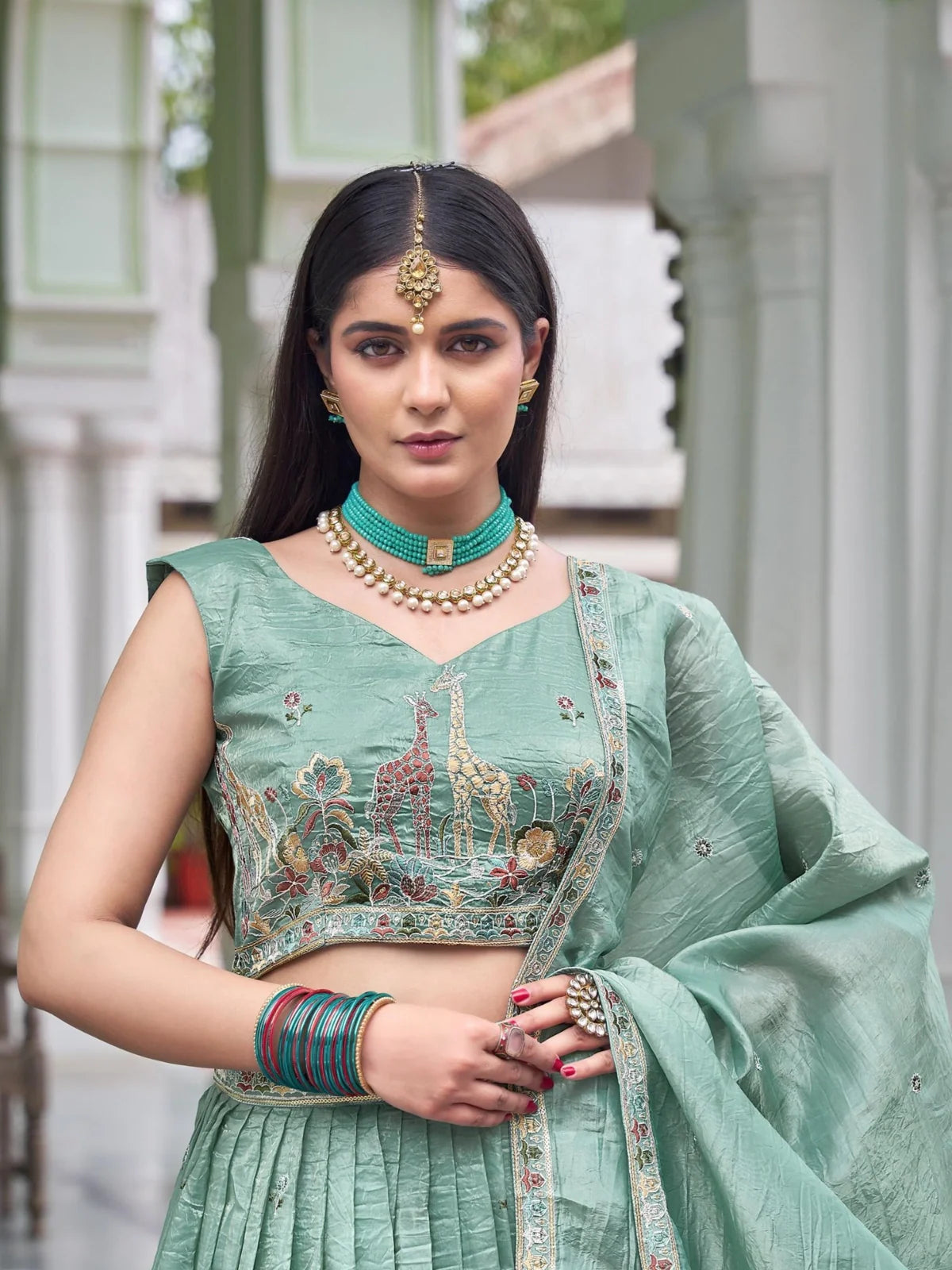 Tarani green silk lehenga close-up showing thread and sequin embroidery on blouse for weddings