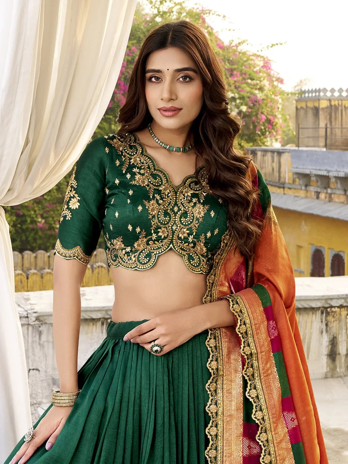 Tarani green lehenga with intricately embroidered blouse and neckline for festive occasions