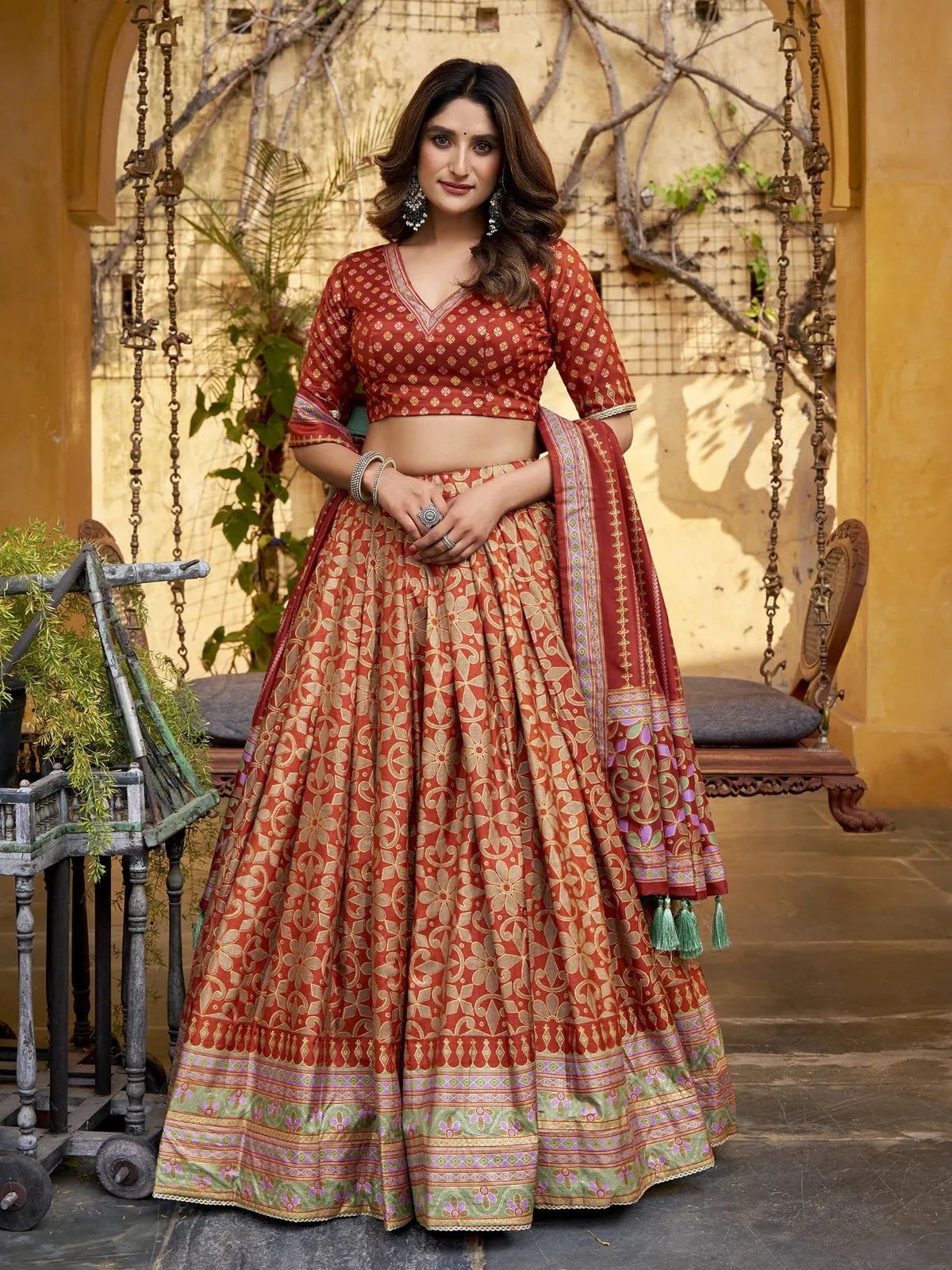 Tarani maroon silk lehenga front view with intricate golden floral weaving and tassel dupatta