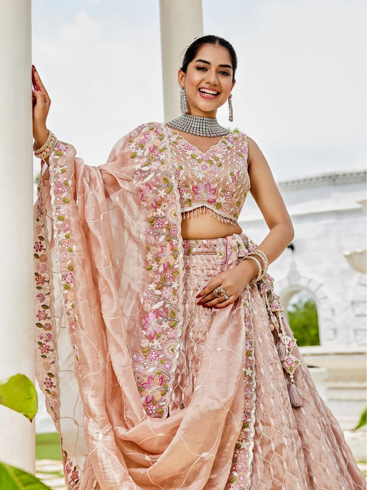 Tarani peach satin silk lehenga upper body view showing embroidered blouse and dupatta