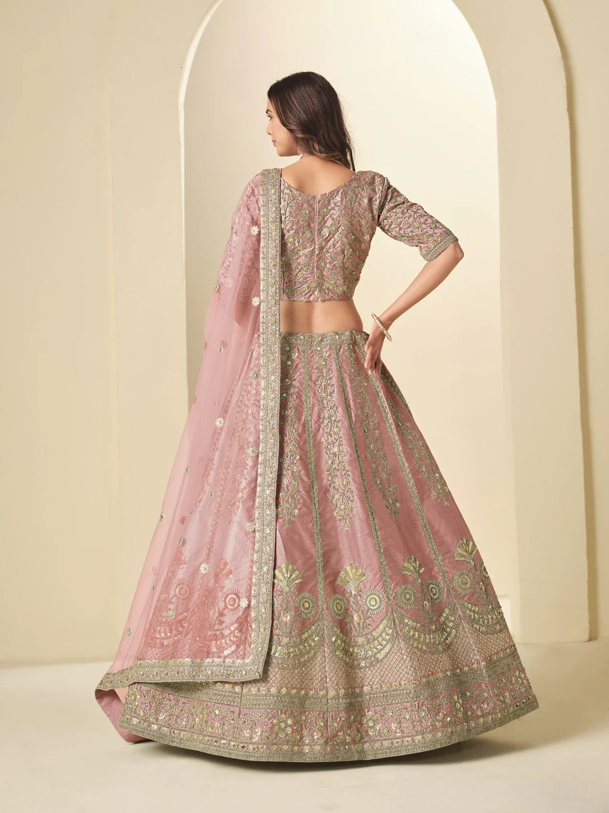 Tarani pink silk lehenga back view highlighting embroidered blouse and lehenga fall