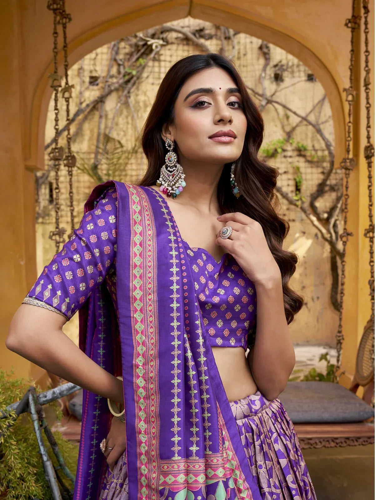 Tarani purple silk lehenga close-up blouse design with half-sleeve scallop cut for festive events