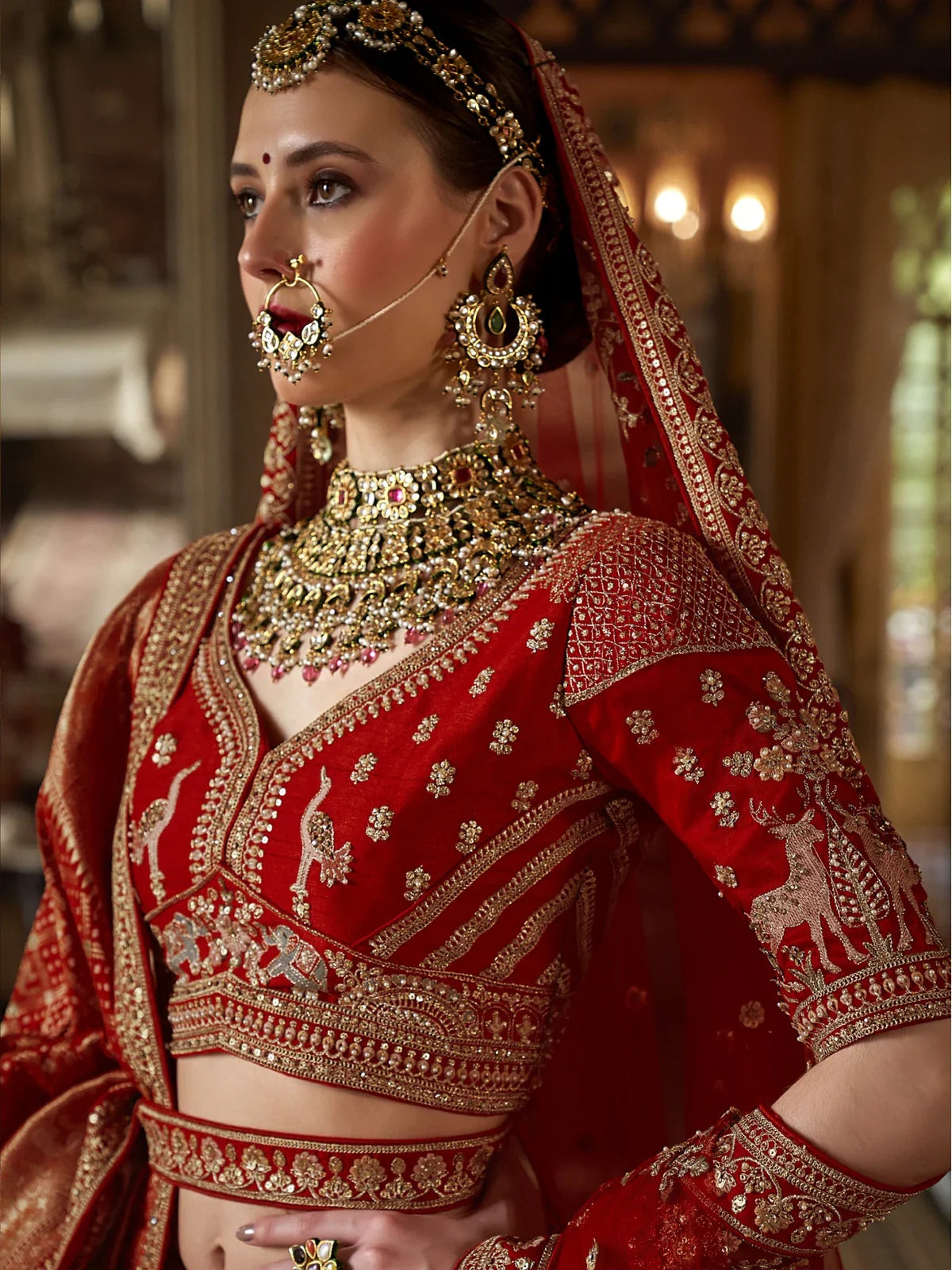 Tarani red silk bridal lehenga upper body view with embroidered blouse and jewellery