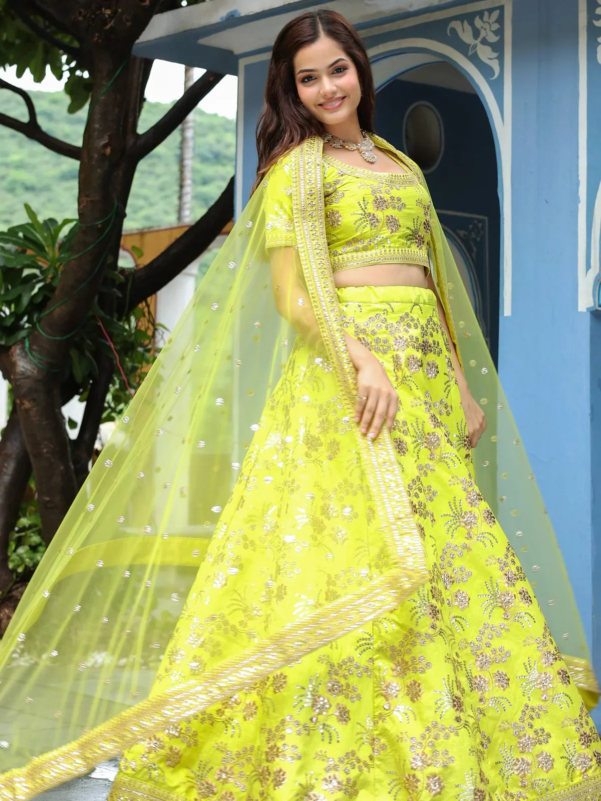 Tarani yellow silk lehenga with net dupatta pallu view