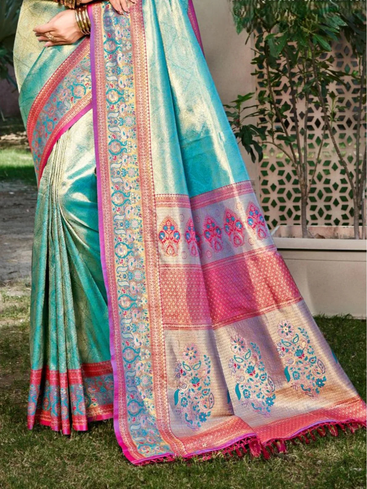 Tarani aqua green kanjivaram silk saree pallu view with detailed pink and blue woven motifs