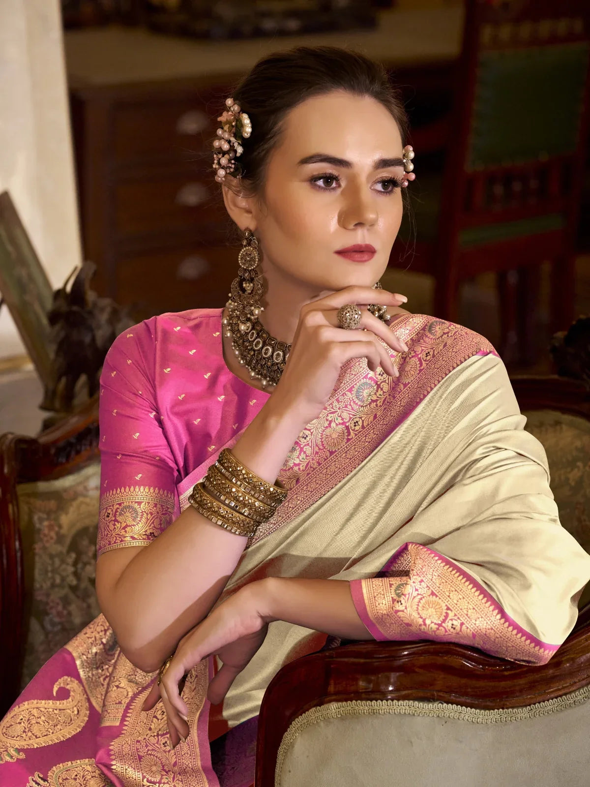 Tarani beige silk saree closeup showing rich zari woven pink paisley motifs