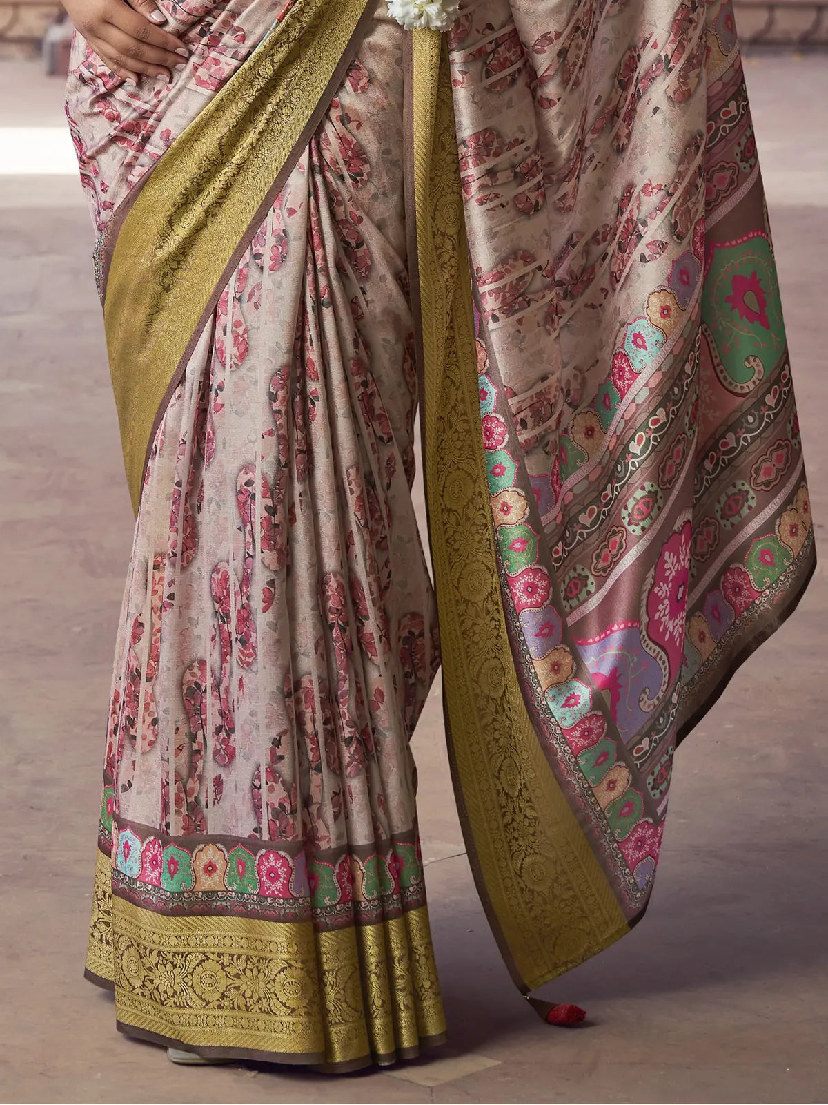Tarani beige silk saree close pallu view with zari border and floral tassels