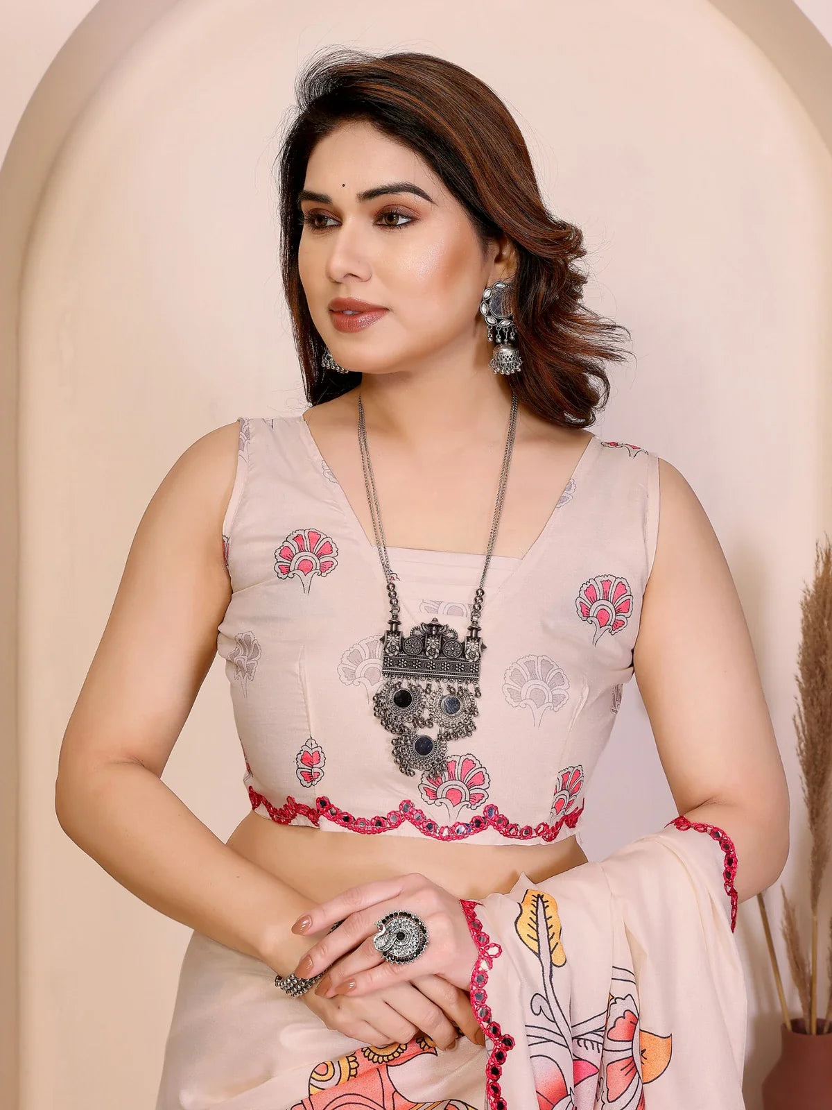 Tarani Manipuri silk saree closeup showing beige blouse with floral embroidery and mirror border