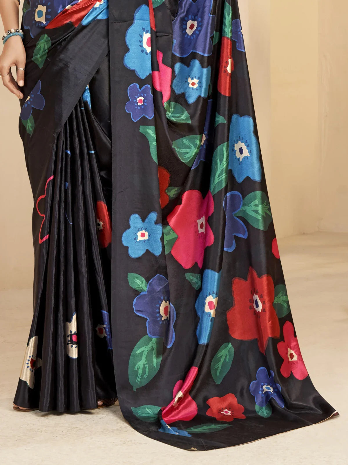 Tarani premium black saree fabric closeup with soft digital print texture