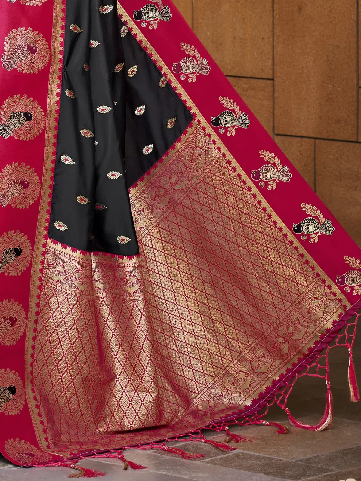 Tarani black and red silk saree featuring golden zari border and traditional pallu closeup
