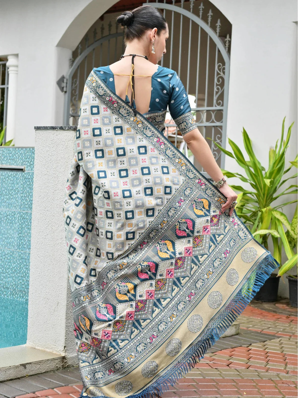 Tarani soft blue silk saree captured from back highlighting blouse design and pallu fall