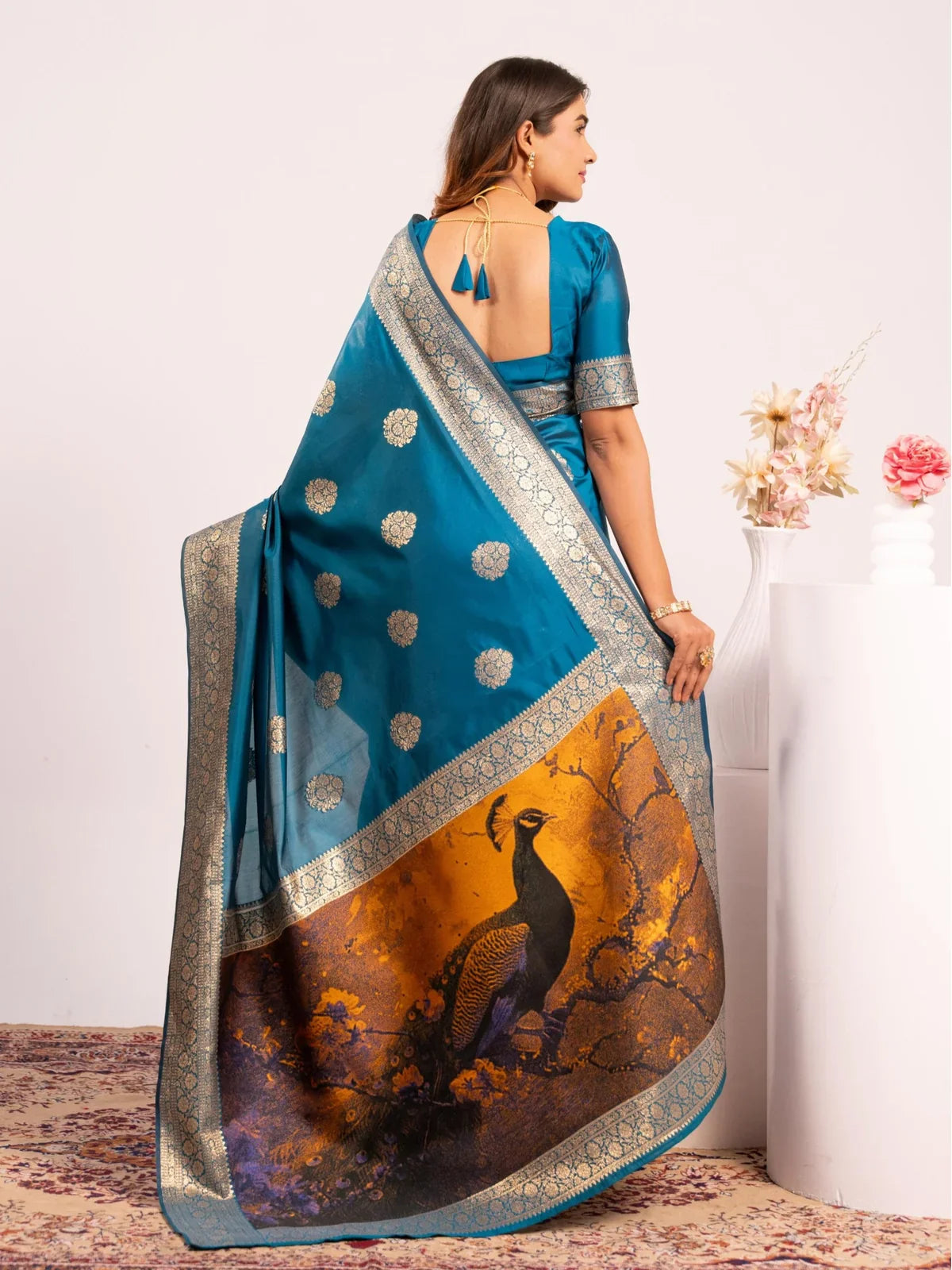 Tarani back view of blue banarasi saree with elegant peacock pallu and blouse detailing