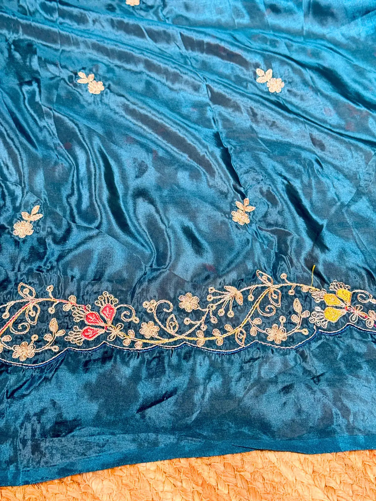 Tarani teal silk saree closeup view of premium fabric with delicate floral design