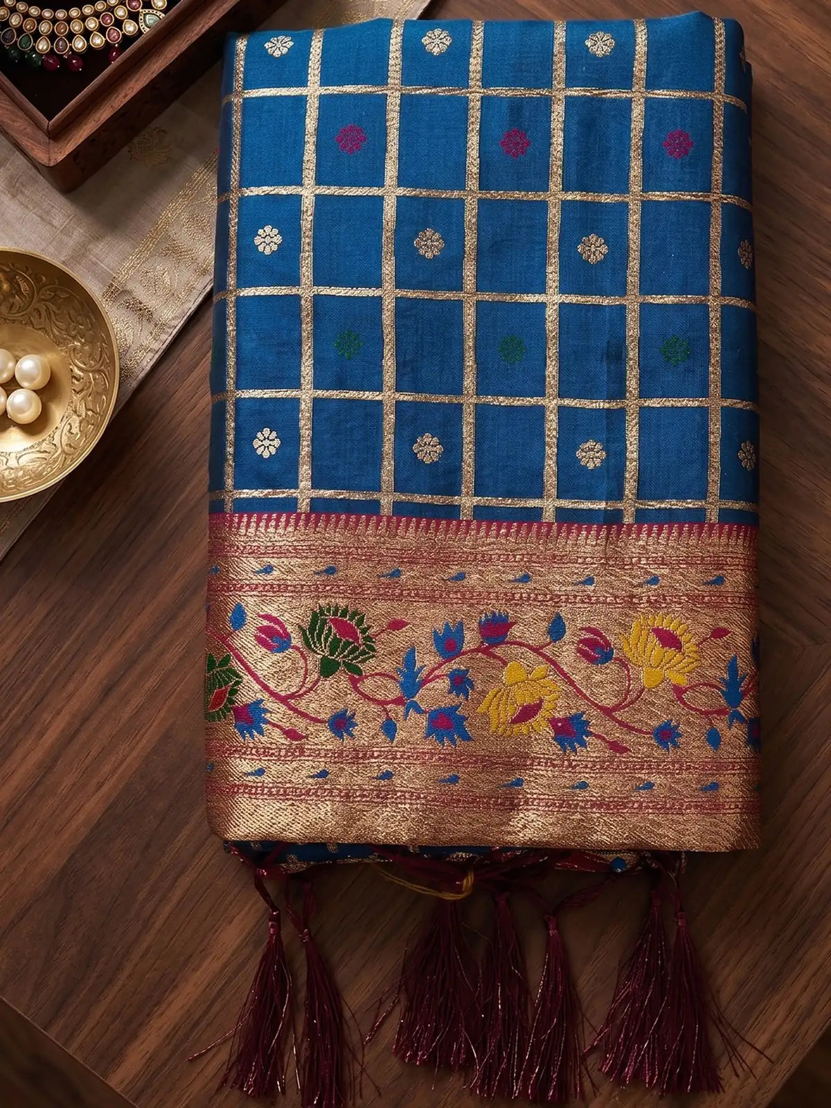 Tarani Archana blue Banarasi silk saree fabric closeup with zari checks and floral border