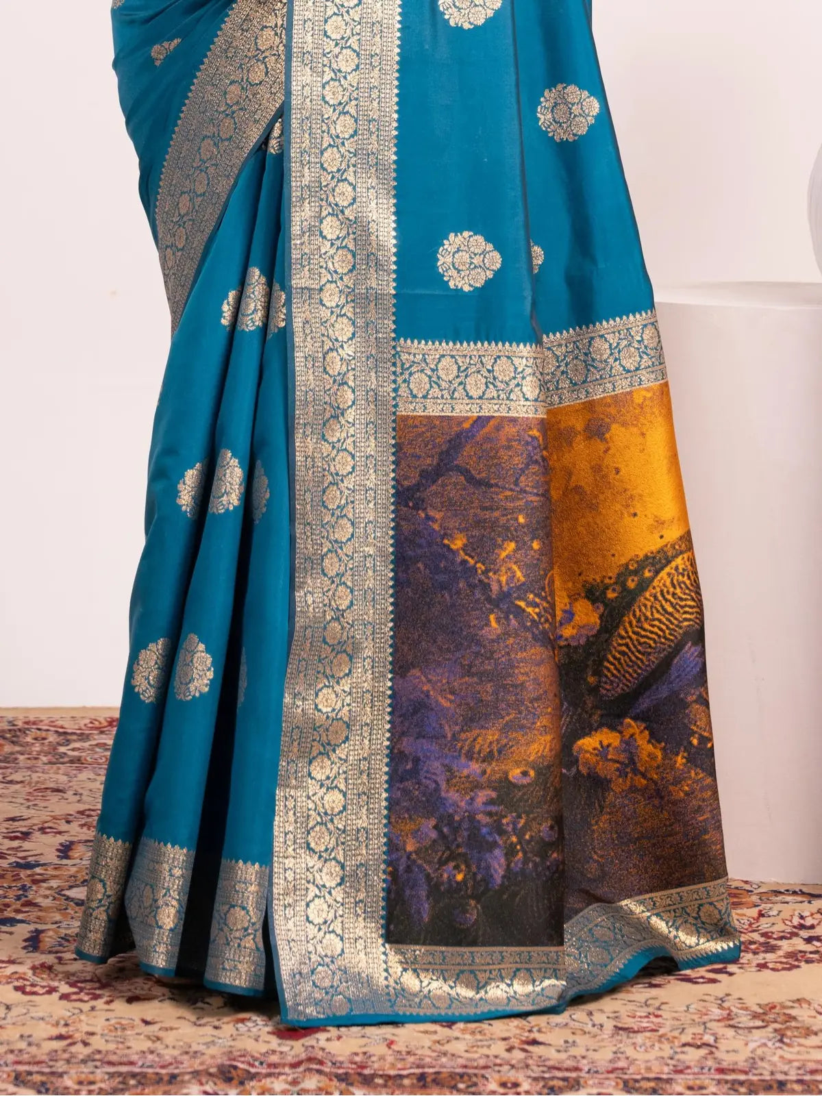 Tarani closeup of blue silk saree fabric showing intricate resham weave and traditional border